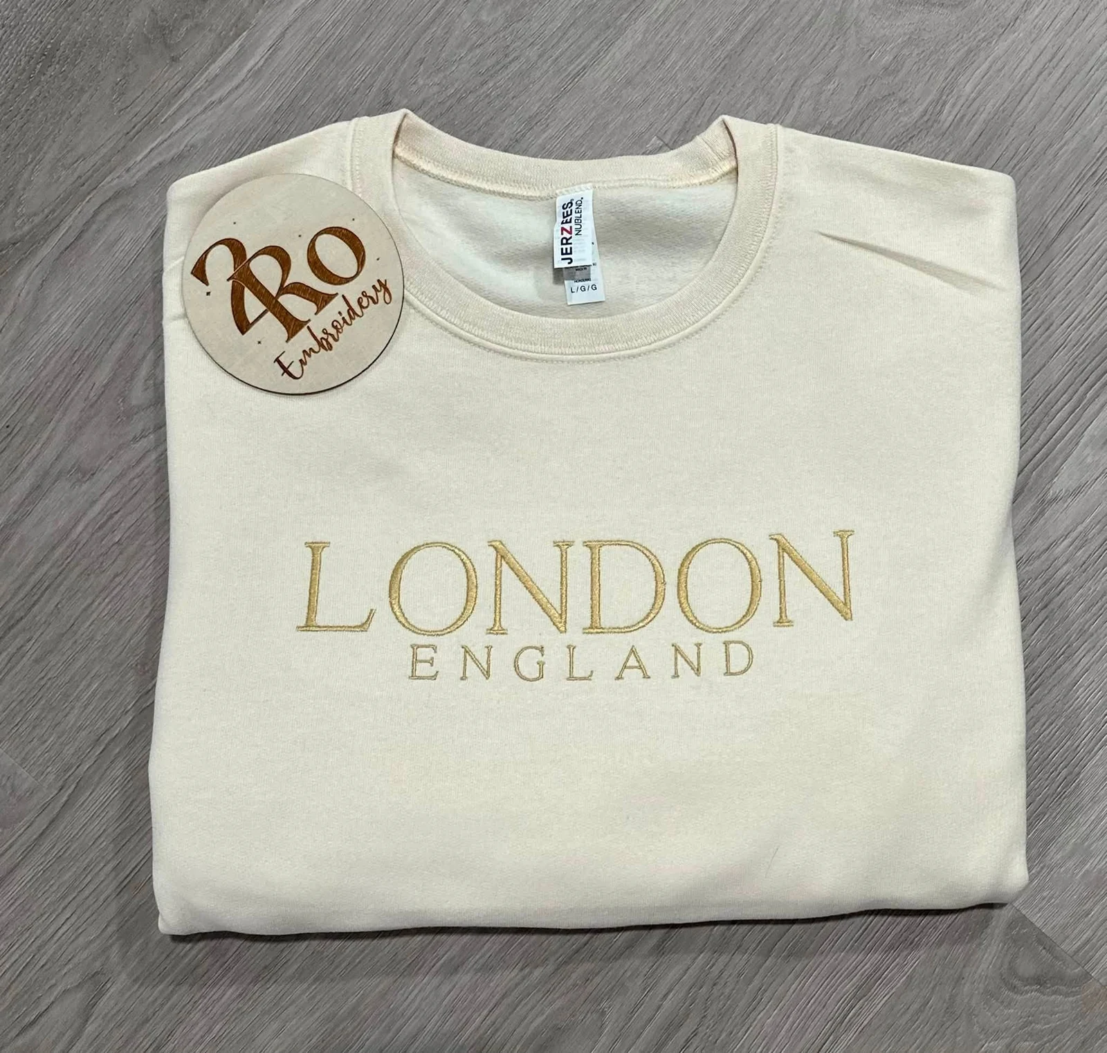 Cream sweatshirt with gold London England embroidery and the 2 Ro Embroidery brand tag