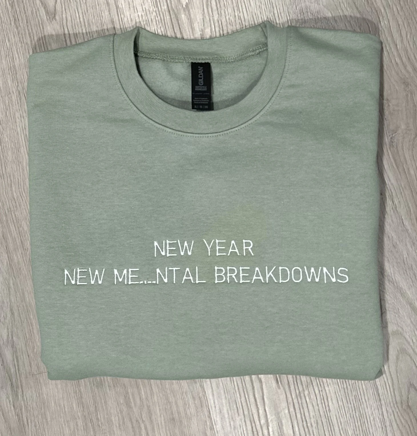 Sage sweatshirt embroidered in white with New year, new me…ntal breakdowns