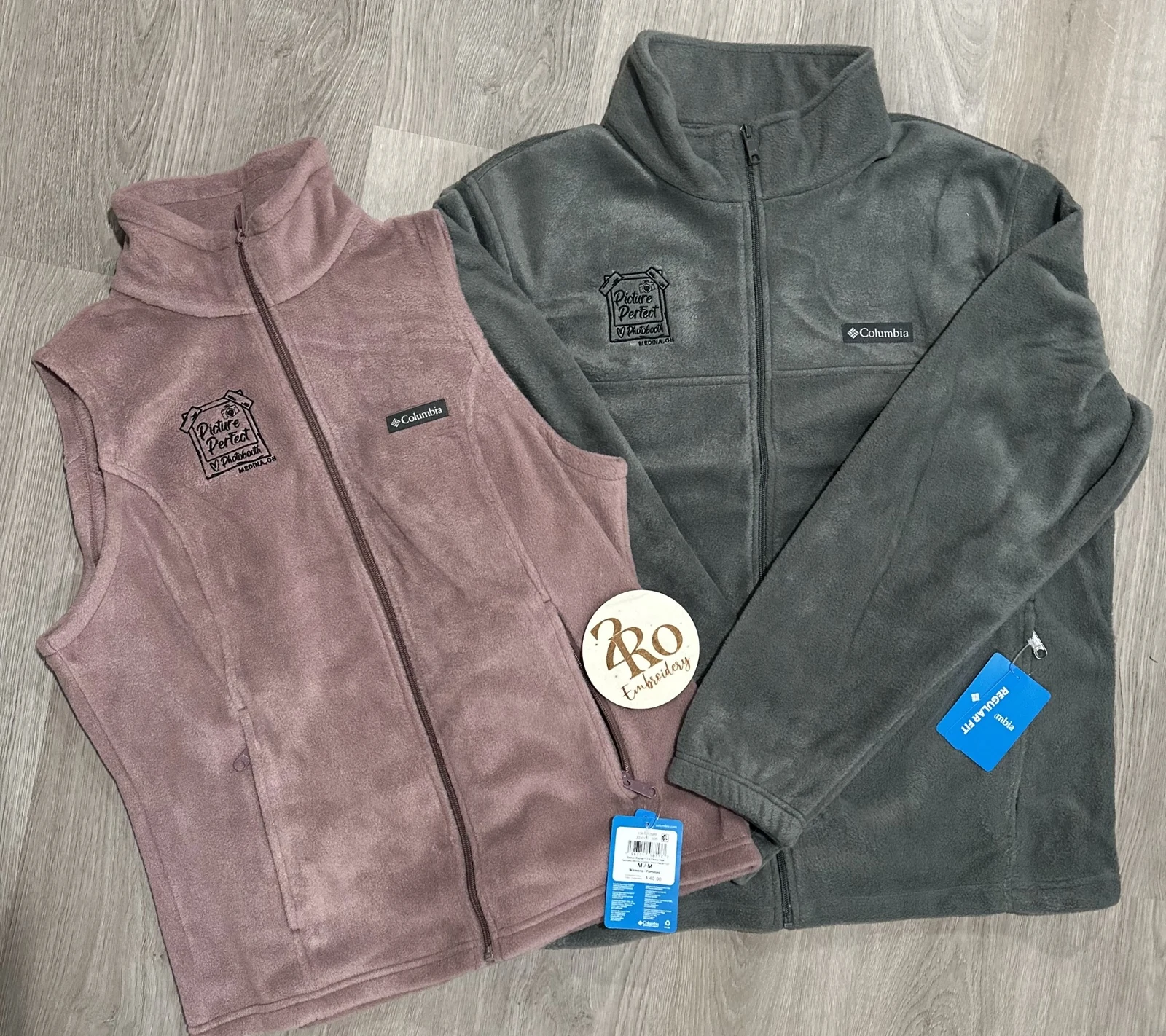 Mauve fleece vest and charcoal fleece jacket embroidered with the Picture Perfect Photobooth logo